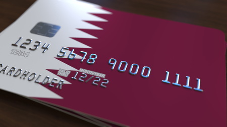 Plastic bank card featuring flag of Qatar. Qatari banking system conceptual 3D renderingの写真素材