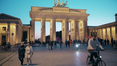 BERLIN, GERMANY - APRIL 30, 2018. Tourists walk near the Brandenburg Gate in the evening