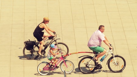 WARSAW, POLAND - MAY 31, 2018. Family cycling with a trailer bike for kidのeditorial素材