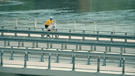 WARSAW, POLAND - MAY 31, 2018. Man cycling along the Vistula river bridgeのeditorial素材