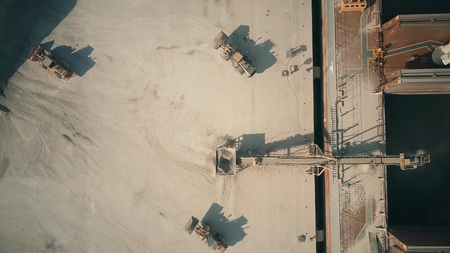 Aerial top down view of dry cargo ship and cement loaders