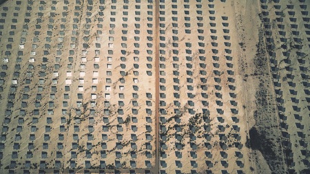 Aerial view of photovoltaic panels reflecting sun. Solar power stationの写真素材