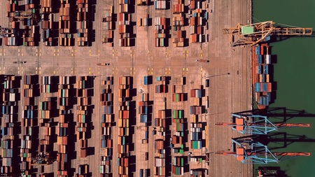 Aerial top-down view of busy seaport container terminal