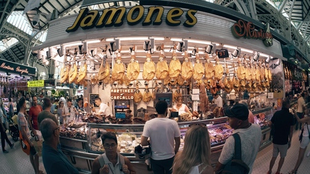 VALENCIA, SPAIN - SEPTEMBER 22, 2018. Fish-eye lens view of jamon meat specialties stall in Mercado Central or Central Marketのeditorial素材