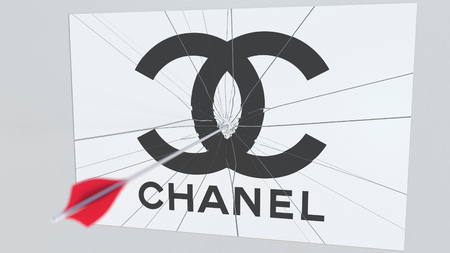 Archery arrow breaks glass plate with CHANEL company logo. Business issue conceptual editorial 3D...