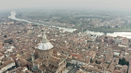Aerial view of Pavia cityscape involving Cathedral and Ponte Coperto or Coperto Bridge across Ticino River. Lombardy, Italyの写真素材