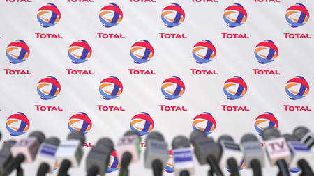 News conference of TOTAL, press wall with logo as a background and mics, editorial 3D rendering