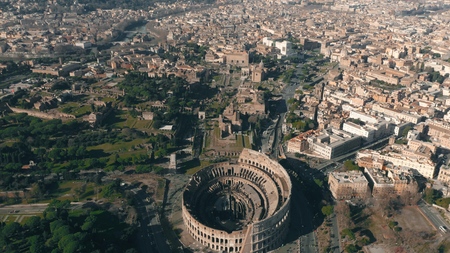 Aerial shot of Colosseum or Coliseum amphitheatre within cityscape of Rome, Italyの写真素材