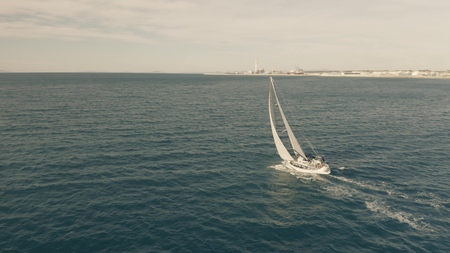 Aerial view of a sailboat sailing at seaの写真素材