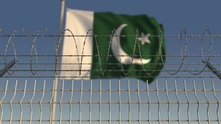 Defocused waving flag of Pakistan behind barbed wire fence. 3D renderingの写真素材