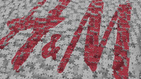H&M logo being composed with puzzle pieces, editorial 3D renderingのeditorial素材