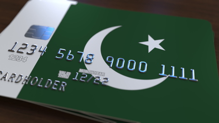 Plastic bank card featuring flag of Pakistan. Pakistani national banking system related 3D renderingの写真素材