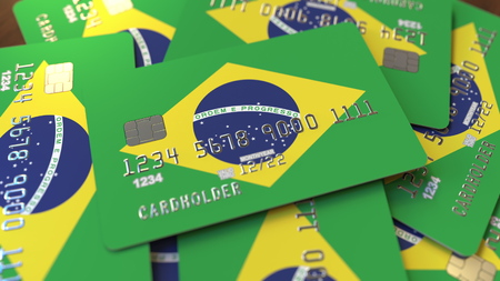 Pile of credit cards with flag of Brazil. Brazilian banking system conceptual 3D renderingの写真素材