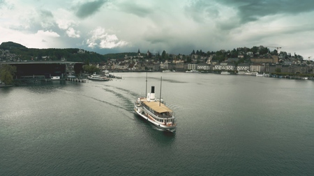 Aerial view of a tour ship on the lake against Lucerne cityscape, Switzerlandの写真素材