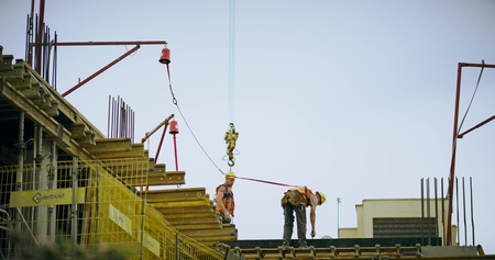 WARSAW, POLAND - MAY 24, 2019. Two workers on a residential building construction site