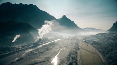 Aerial view of polluting plant in the river valley, northern Italyの写真素材