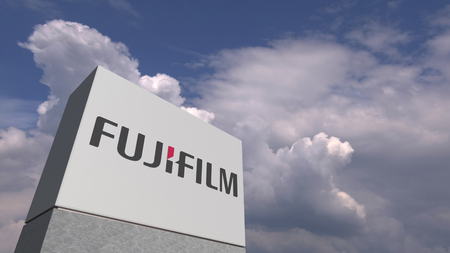 Logo of FUJIFILM on a stand against cloudy sky, editorial 3D renderingのeditorial素材