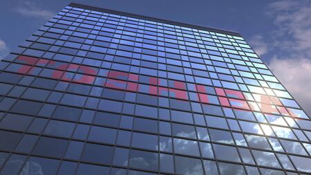 Logo of TOSHIBA on a media facade with reflecting cloudy sky, editorial 3D rendering