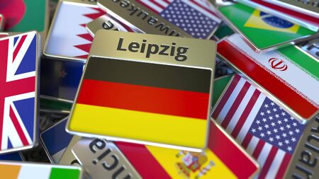 Souvenir magnet or badge with Leipzig text and national flag among different ones. Traveling to Germany conceptual 3D renderingの写真素材