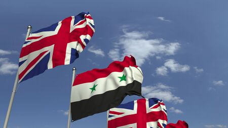 Flags of Syria and the United Kingdom against blue sky, 3D renderingの写真素材