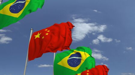 Waving flags of Brazil and China on sky background, 3D renderingの写真素材