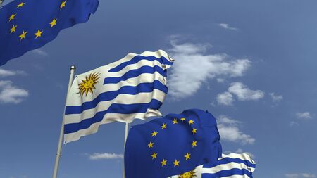 Flags of Uruguay and the European Union against blue sky, 3D rendering