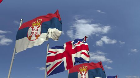 Waving flags of Serbia and the United Kingdom on sky background, 3D renderingの写真素材