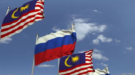 Flags of Malaysia and Russia against blue sky, 3D renderingの写真素材