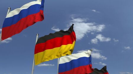 Flags of Russia and Germany against blue sky, 3D renderingの写真素材