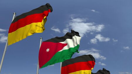 Waving flags of Jordan and Germany on sky background, 3D renderingの写真素材