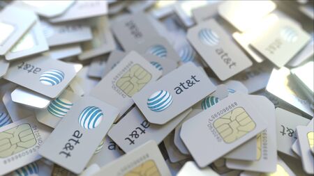 Pile of SIM cards with AT&T Inc. logo, close-up. Editorial telecommunication related 3D renderingのeditorial素材