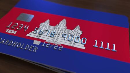 Plastic bank card featuring flag of Cambodia. Cambodian national banking system related 3D renderingの写真素材