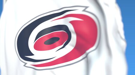 Waving flag with Carolina Hurricanes NHL hockey team logo, close-up. Editorial 3D rendering