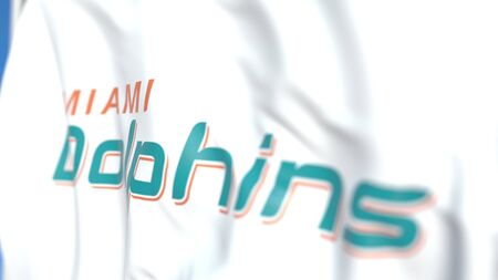 Waving flag with Miami Dolphins team logo, close-up. Editorial 3D rendering