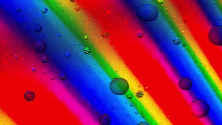 Water drops cover rainbow LCD screen, macro shot