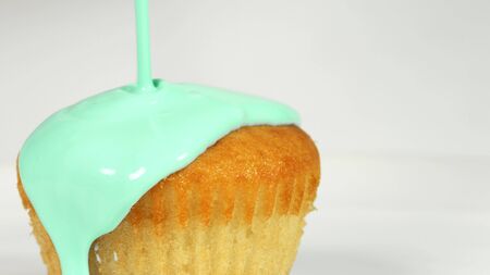 Pouring cyan icing over cake, macro shotの写真素材