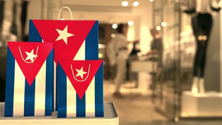Flag of Cuba on the paper shopping bags against blurred store entrance. Retail related 3D rendering