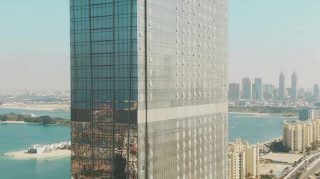 Aerial view of skyscrapers windows reflecting cityscape. Palm Jumeirah island in Dubai, UAE