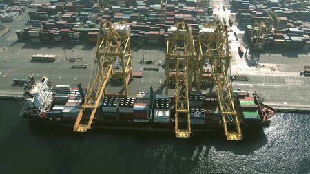 DUBAI, UNITED ARAB EMIRATES - DECEMBER 29, 2019. Aerial view of a docked container ship being loaded...