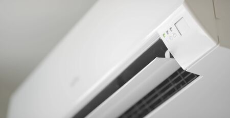 Modern wall mounted air conditioner in action, close-up shotの写真素材