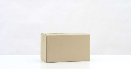 Blank cardboard box on white table