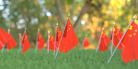 Small National flags of China in the grass. Celebration related 3D renderingの写真素材