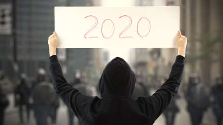 Unknown protester holds a placard with 2020 textの写真素材