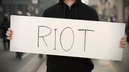 RIOT text on an activism bannerの写真素材 [40154834467] - イメージマート