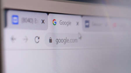 Google domain name in browser and logo on the computer screen. Editorial macro shotのeditorial素材