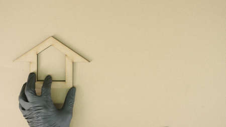 Putting home icon made of recycled cardboard on the table. Sustainable living conceptの写真素材