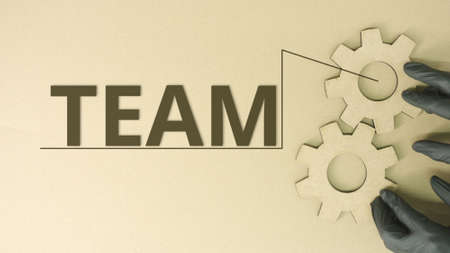 Team word at cogwheels made from recycled cardboardの写真素材