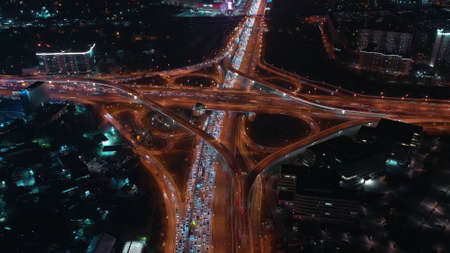 Long exposure aerial shot of a busy road interchange and rush hour traffic jam in the evening