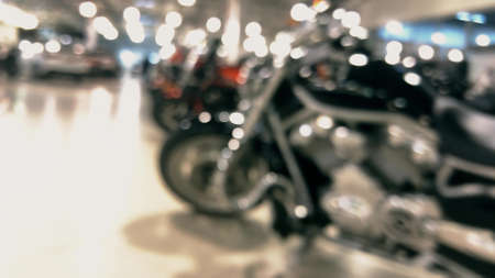 Blurred polished motorcycles in a dealership showroom