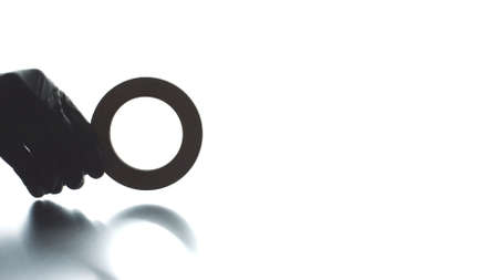 Putting magnifying glass black icon on light background, search conceptの写真素材